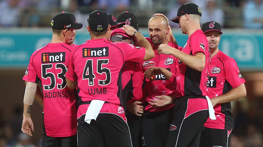 Nathan Lyon is mobbed by team-mates after taking a wicket